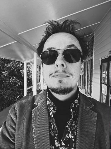 Black-and-white photo of Mirko Ruckels in sunglasses and a blazer